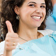 Smiling woman giving thumbs up