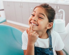 little girl showing off her teeth to her children’s dentist in Oklahoma City