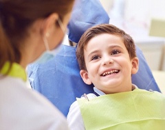 little boy smiling at his dentist