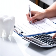 Person calculating the cost of cosmetic dentistry in Oklahoma City