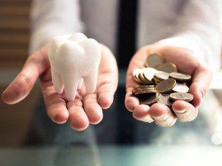 tooth in one hand, coins in the other