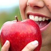 close up person eating an apple 