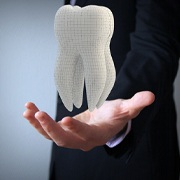 Hand holding digital tooth