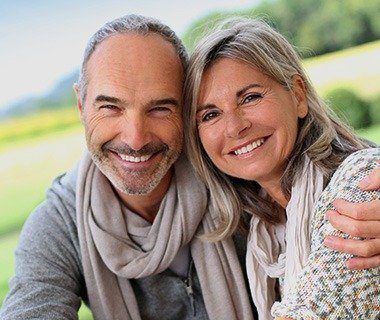 Smiling older man and woman outdoors
