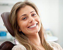 young woman smiling with dental implants in Oklahoma City