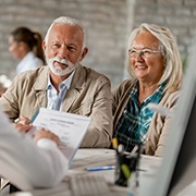 elderly couple at a dental implant consultation