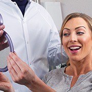 Woman looking at smile in mirror