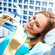 young woman smiling in dental chair