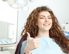 woman giving thumbs up before receiving IV sedation in Oklahoma City