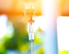 IV drip in front of a window with nature outside