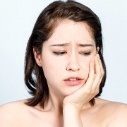 woman with jaw pain from teeth grinding in Oklahoma City