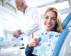 woman giving thumbs up at oral cancer screening in Oklahoma City