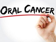 hand underlining the words “oral cancer” with marker
