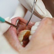 dentist treating patient with gum disease