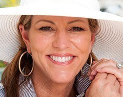 Smiling woman wearing large sun hat