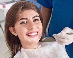 Woman with healthy smile in dental chair