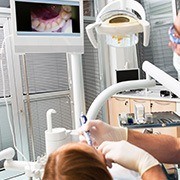 Dentist and patient looking at intraoral photos