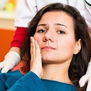 Woman holding cheek in pain